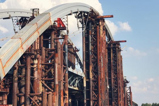 Abandoned old bridge, big engineering construction with metal concrete