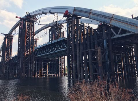 Abandoned old bridge, big engineering construction with metal concrete