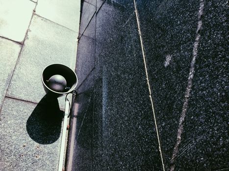 Old metal loudspeakers on marmoreal wall of subway in black and white