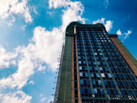 Top part of high-rise business building on blue sky 