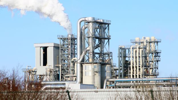 Factory smokes a tree. White smoke from the chimney on blue sky background. Ecology industry environment factory pollution