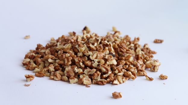 Spill purified walnut on white background, Drupe pile heap