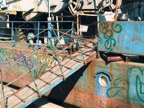 Graffiti background. Urban street art on abandoned ship ferry  port pier