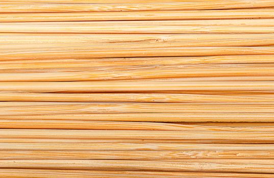 Closeup abstract background of bamboo sticks stacked next to each other