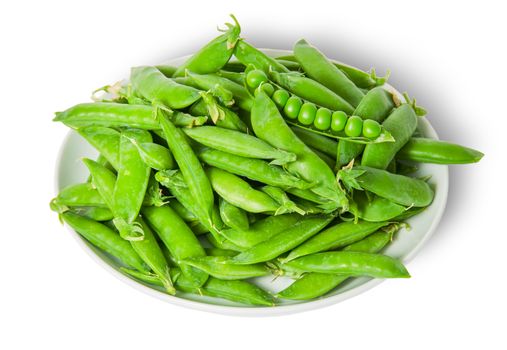 Big pile opening and closing pea pods on white plate isolated on white background