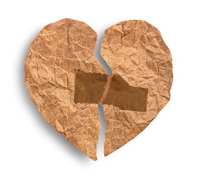 Broken crumpled paper heart coupled with tape isolated on white background