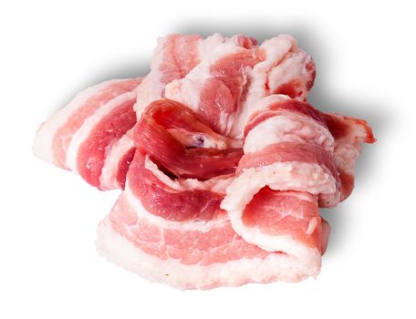Chaotic stacked strips of bacon isolated on white background