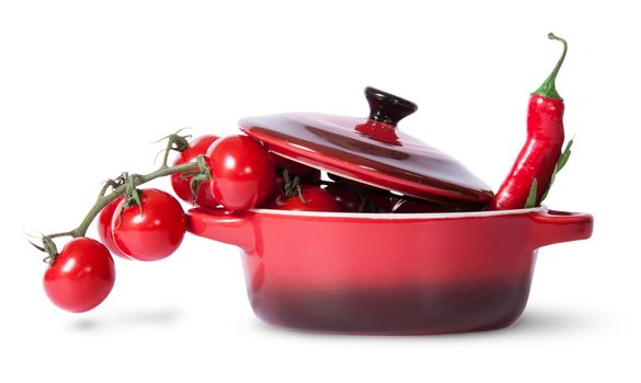 Cherry tomatoes with parsley and chili in saucepan isolated on white background