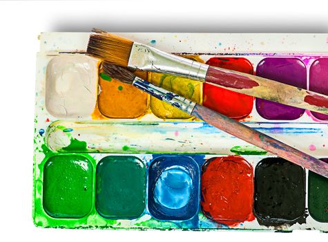 Closeup of watercolor paints set and brushes isolated on white background