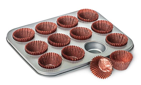 Cupcake and muffin pan with paper cups some beside isolated on white background