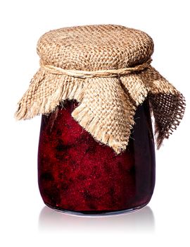 Currant jam in jar with burlap isolated on white background