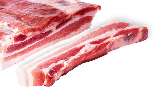 Cut a piece of bacon next to a large isolated on white background