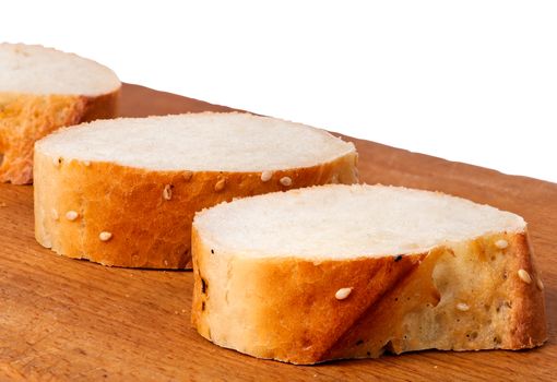 Photo of delicious fresh bread sliced on a wooden board