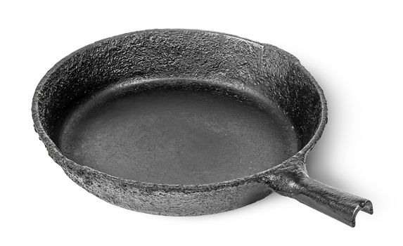 Empty old cast iron frying pan rotated isolated on white background