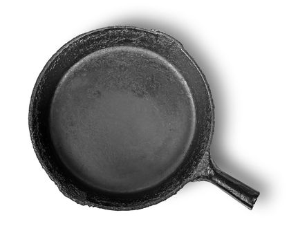 Empty old cast iron frying pan isolated on white background