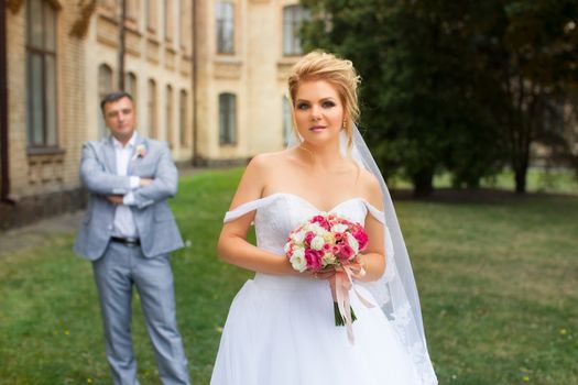 Newlyweds on a walk in the summer day wedding