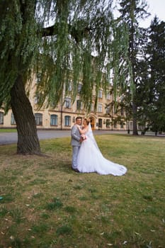 Newlyweds on a walk in the summer day wedding