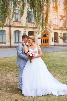 Newlyweds on a walk in the summer day wedding