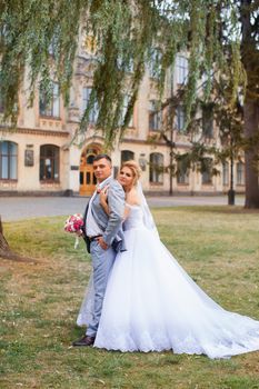 Newlyweds on a walk in the summer day wedding