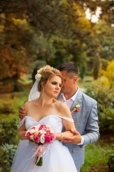 Newlyweds on a walk in the summer day wedding