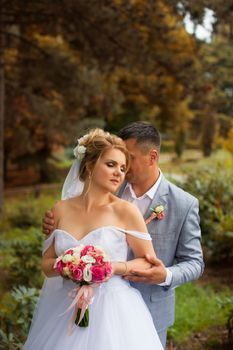 Newlyweds on a walk in the summer day wedding