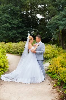 Newlyweds on a walk in the summer day wedding