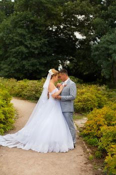 Newlyweds on a walk in the summer day wedding