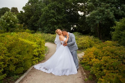 Newlyweds on a walk in the summer day wedding