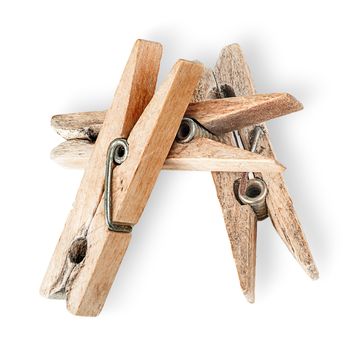 Heap of old wooden clothespins isolated on white background