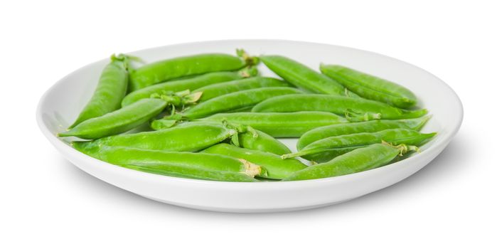 In front several pods of peas on a white plate isolated on white background