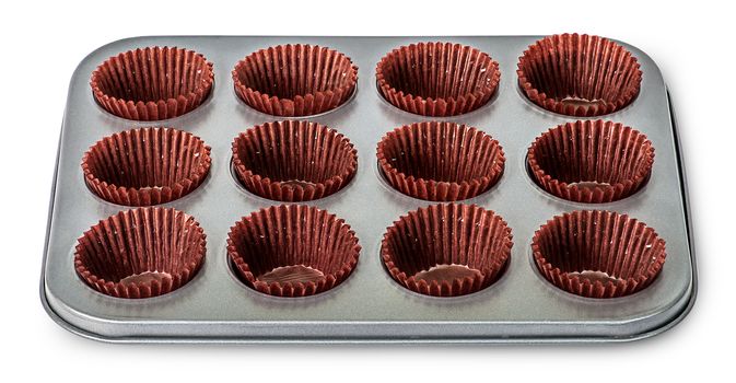 In front cupcake and muffin pan with paper cups isolated on white background