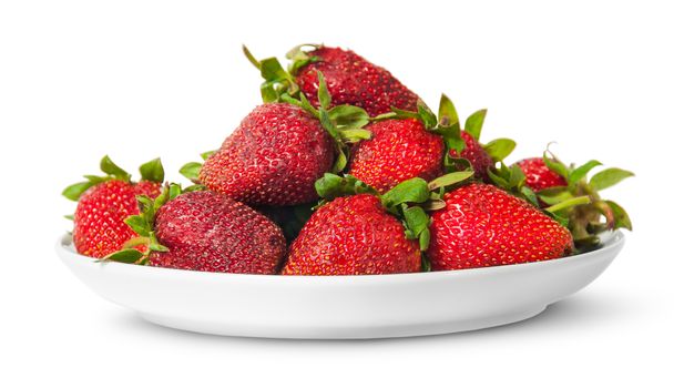 In front pile of fresh juicy strawberries on white plate isolated on white background