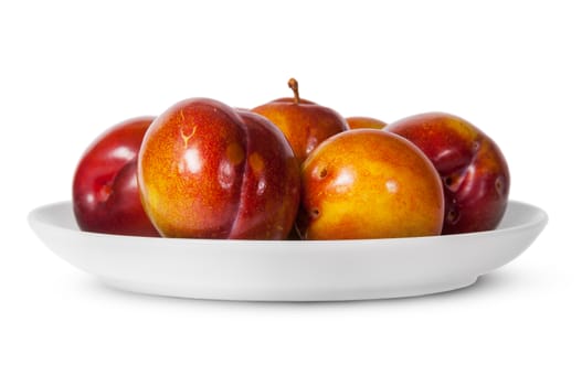 In front red and yellow plums on white plate isolated on white background