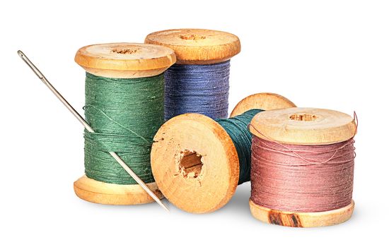 Needle and multicolored thread on wooden spool isolated on white background