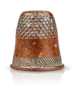 Old antique copper thimble isolated on white background