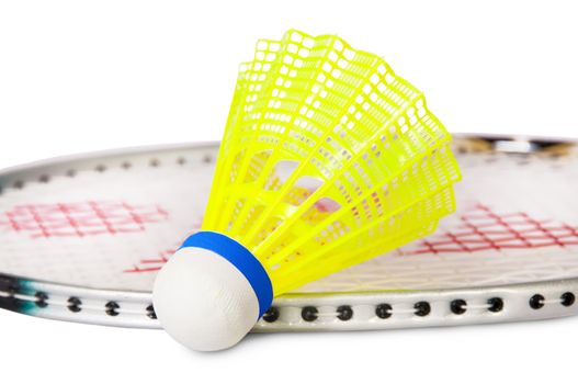 One shuttlecock lying near the badminton racket isolated on white background