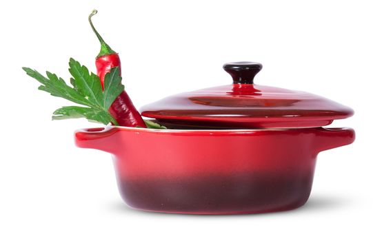 Parsley with red chili pepper in saucepan isolated on white background