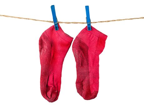 Pair of washed red socks on rope isolated on white background