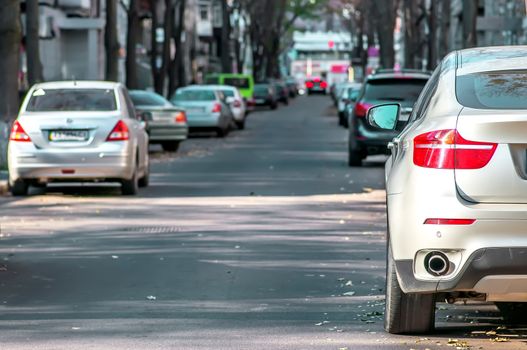 Parked cars on both sides of the city street