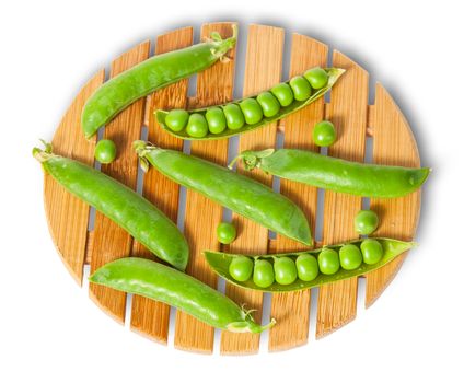 Pods of peas on bamboo board top and front view isolated on white background