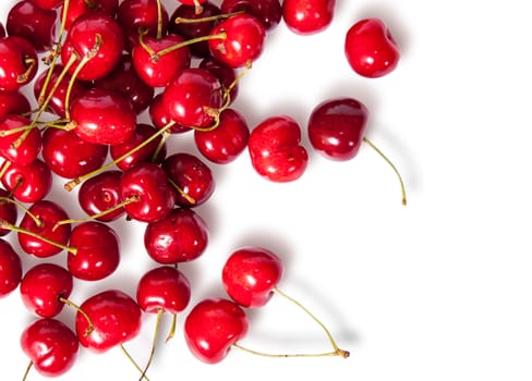 Pours pile of juicy sweet cherries isolated on white background