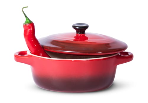 Red chili pepper in saucepan with lid isolated on white background