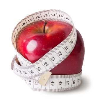 Red apple with sewing measuring isolated on white background