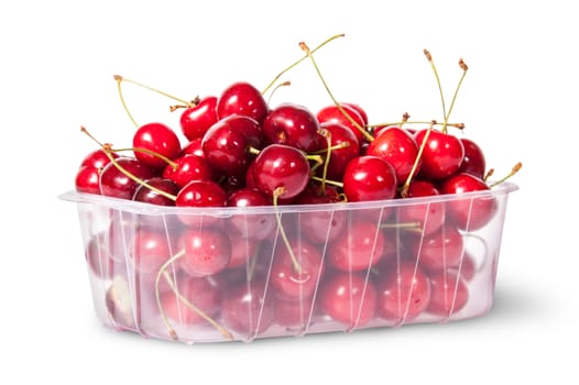 Red juicy sweet cherries in a plastic tray rotated isolated on white background