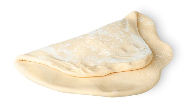 Roll the piece of dough folded in half isolated on white background