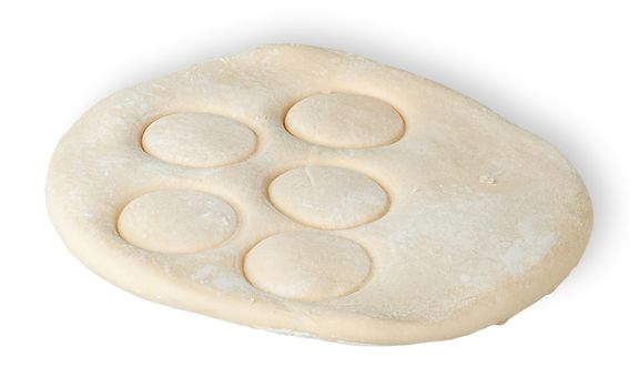 Roll dough with pressed through circles isolated on white background