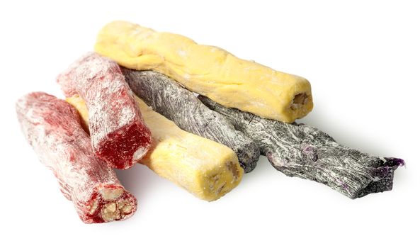 Several pieces of Turkish Delight in a row isolated on white background