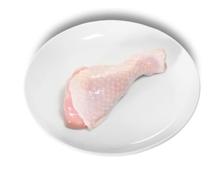 Single Raw Chicken Legs On White Plate Isolated On White Background