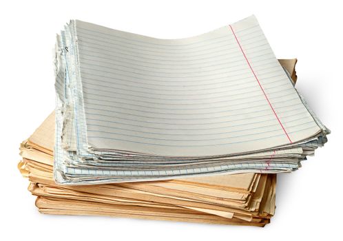 Stack of old yellowed sheets of school notebooks isolated on white background