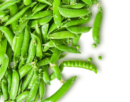 The scattered pods of green peas isolated on white background